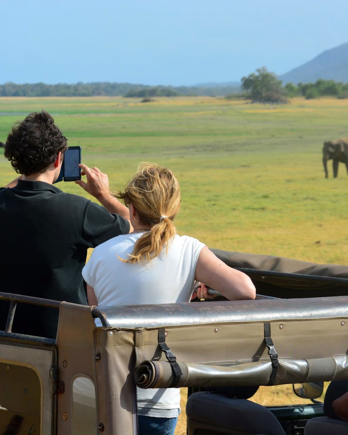 A couple watching elephants from a safari jeep in Sri Lanka