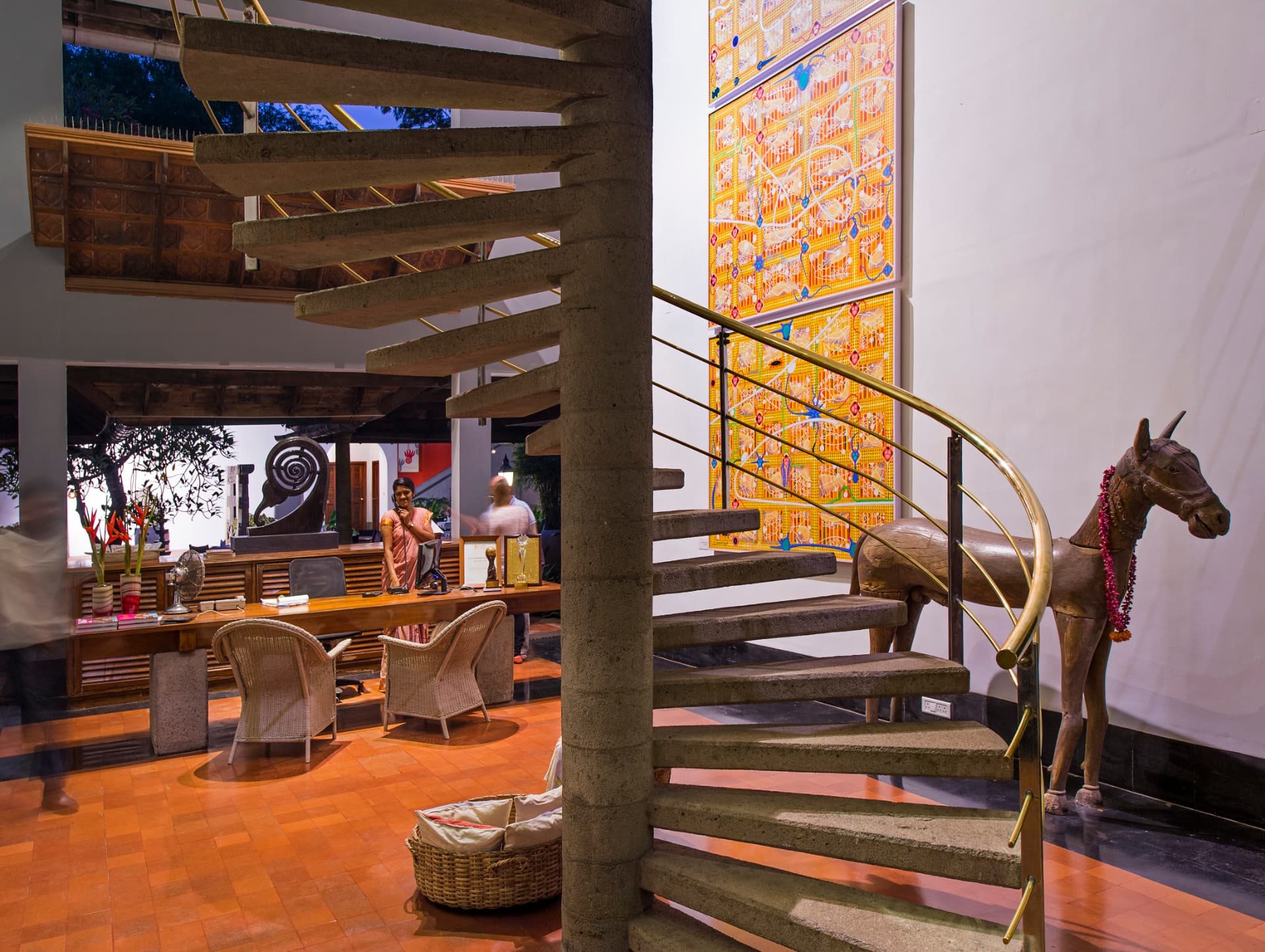 Reception with spiral staircase and art at The Malabar House