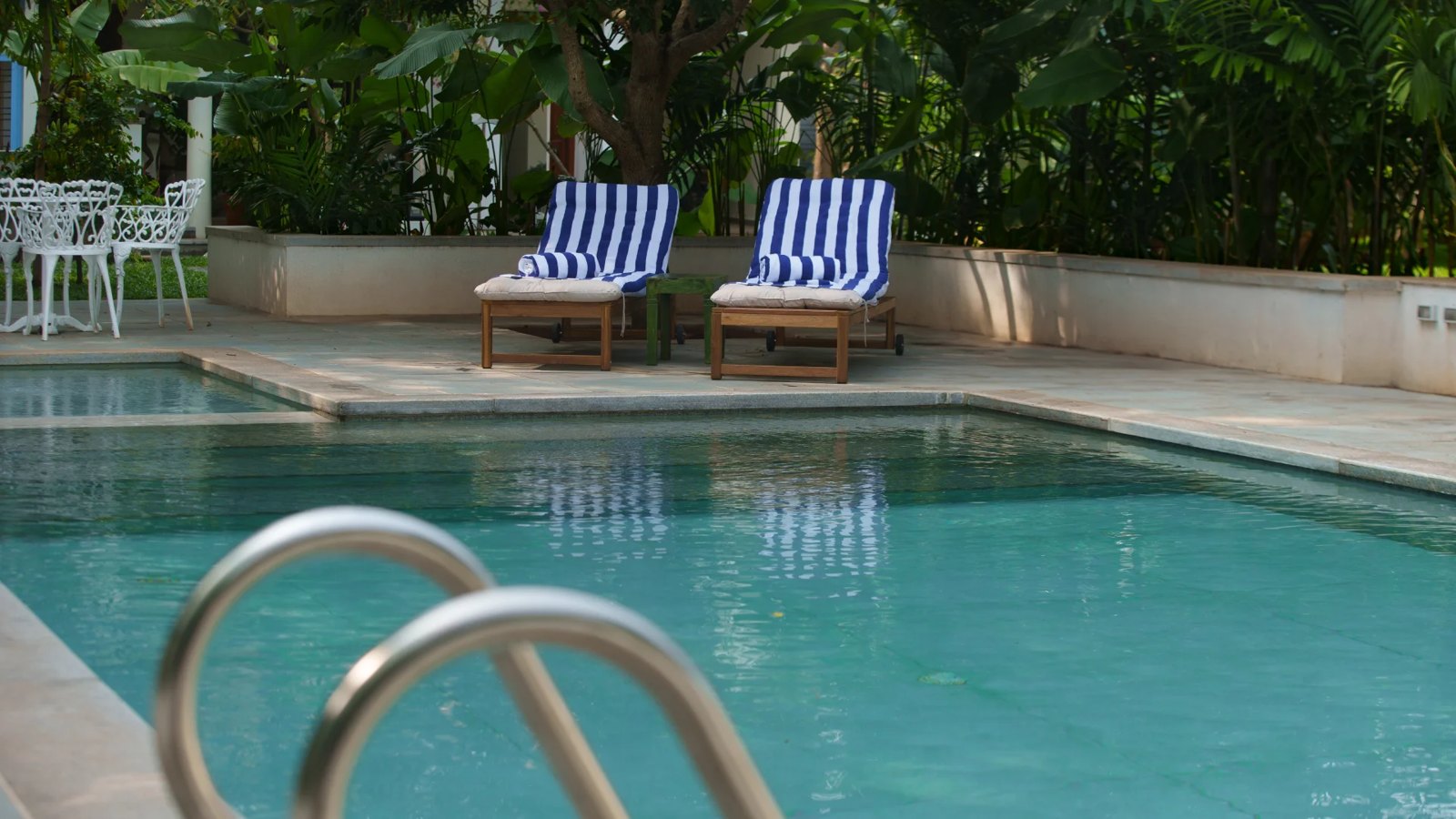 Swimming pool and sun loungers at Isai Karai Bungalow