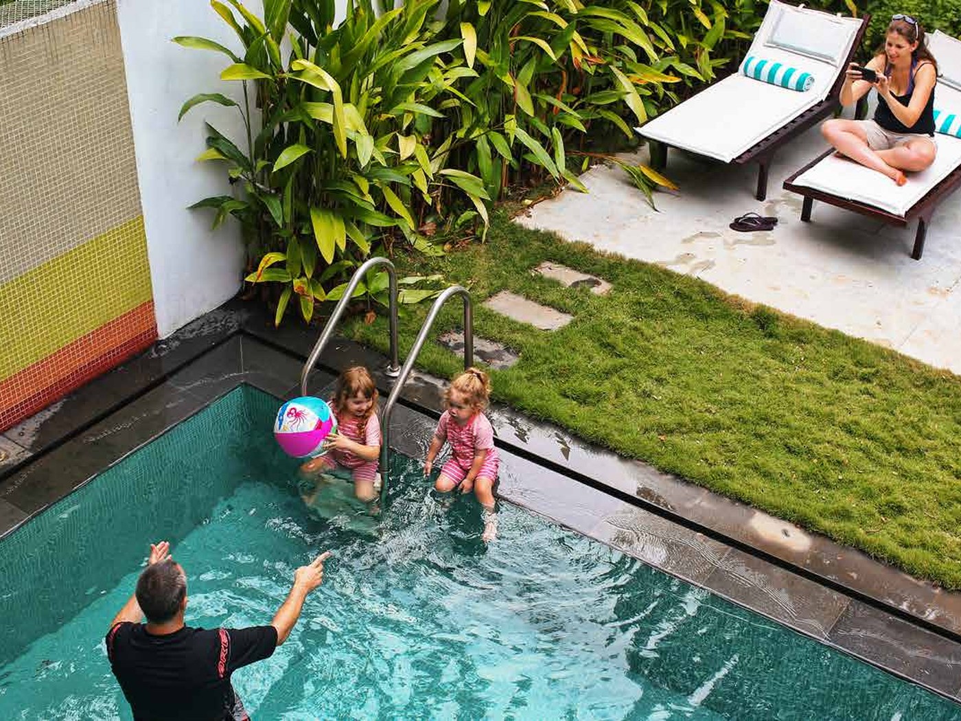 Family swimming in the private pool at Beach Gate Bungalows