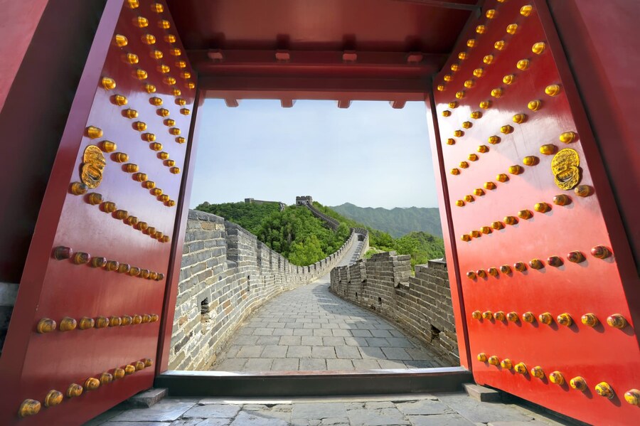 The Great Wall seen through open red and gold studded gates