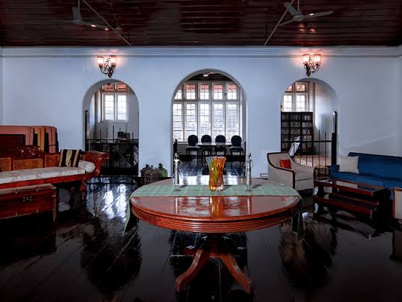Drawing room at Koder House with arched windows and antique Kerala furniture