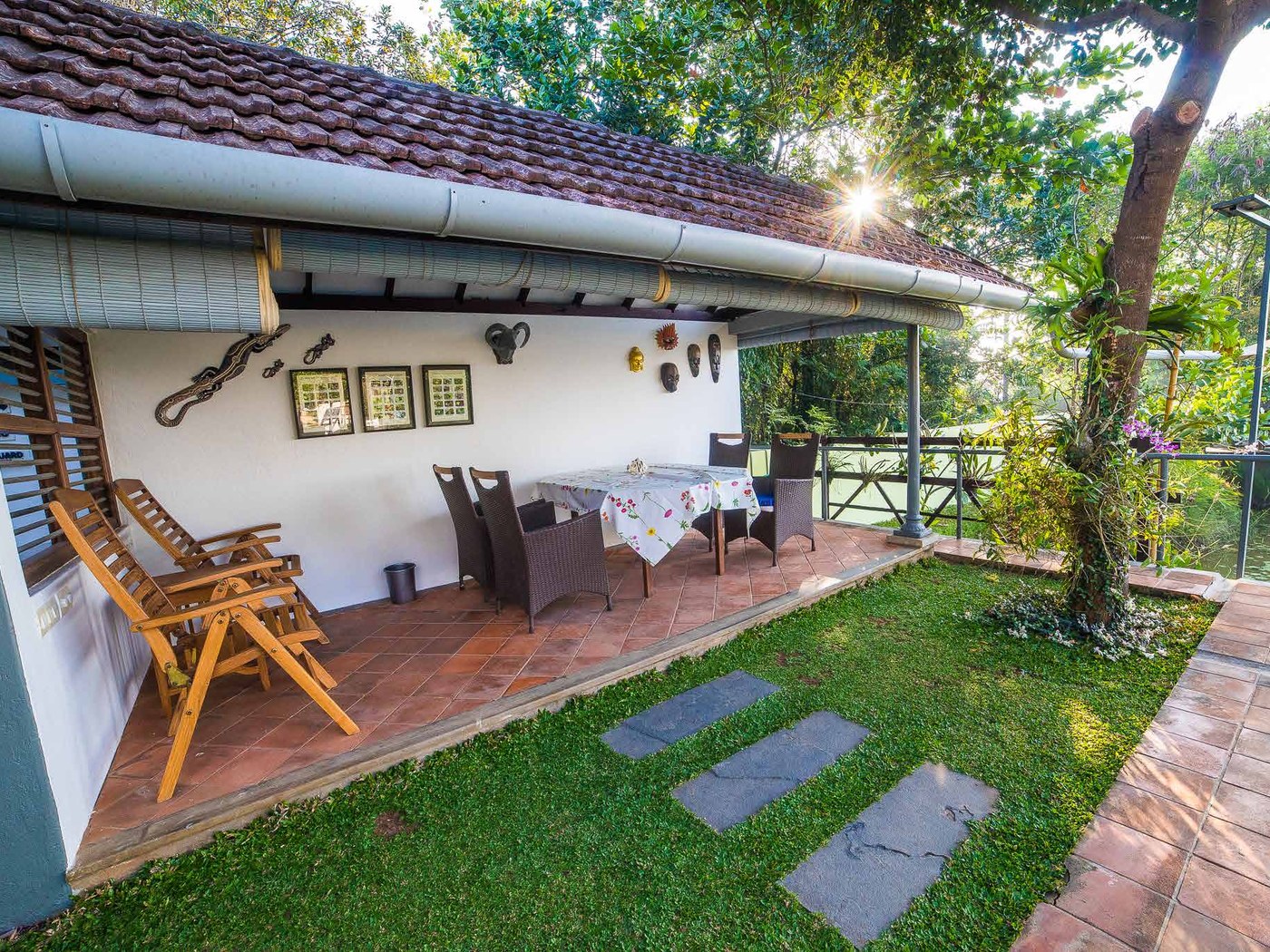 Shaded verandah and lawn at Hibiscus Villa