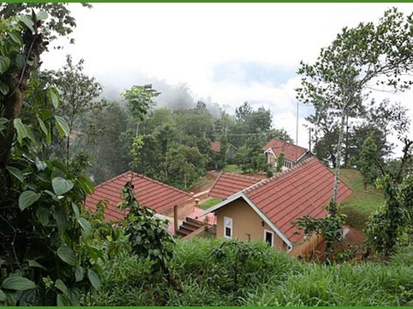 Tiled-roof cottages set among plantation greenery at My Garden of Eden