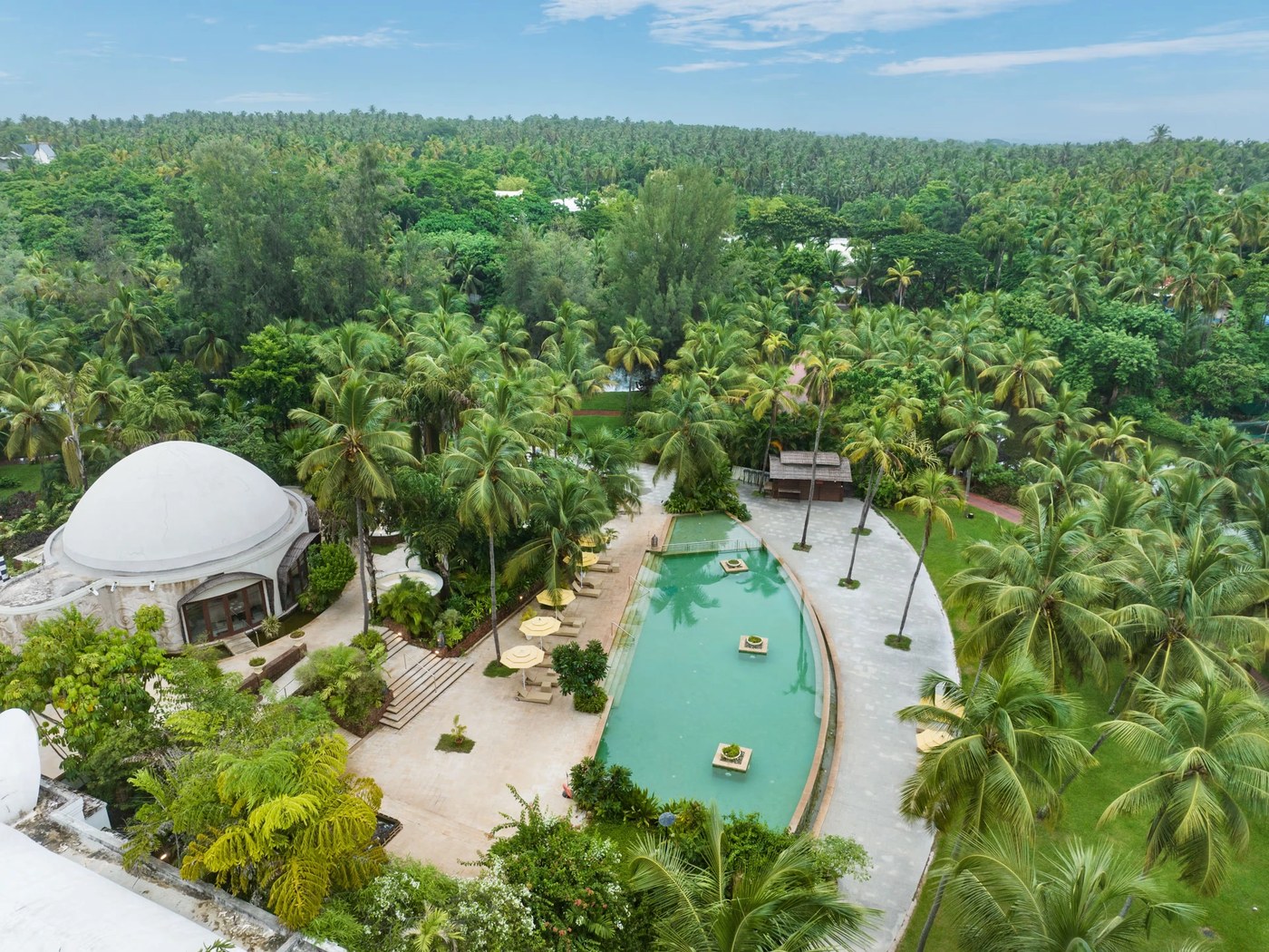 Aerial view of the pool and palm groves at Vivanta by Taj Bekal