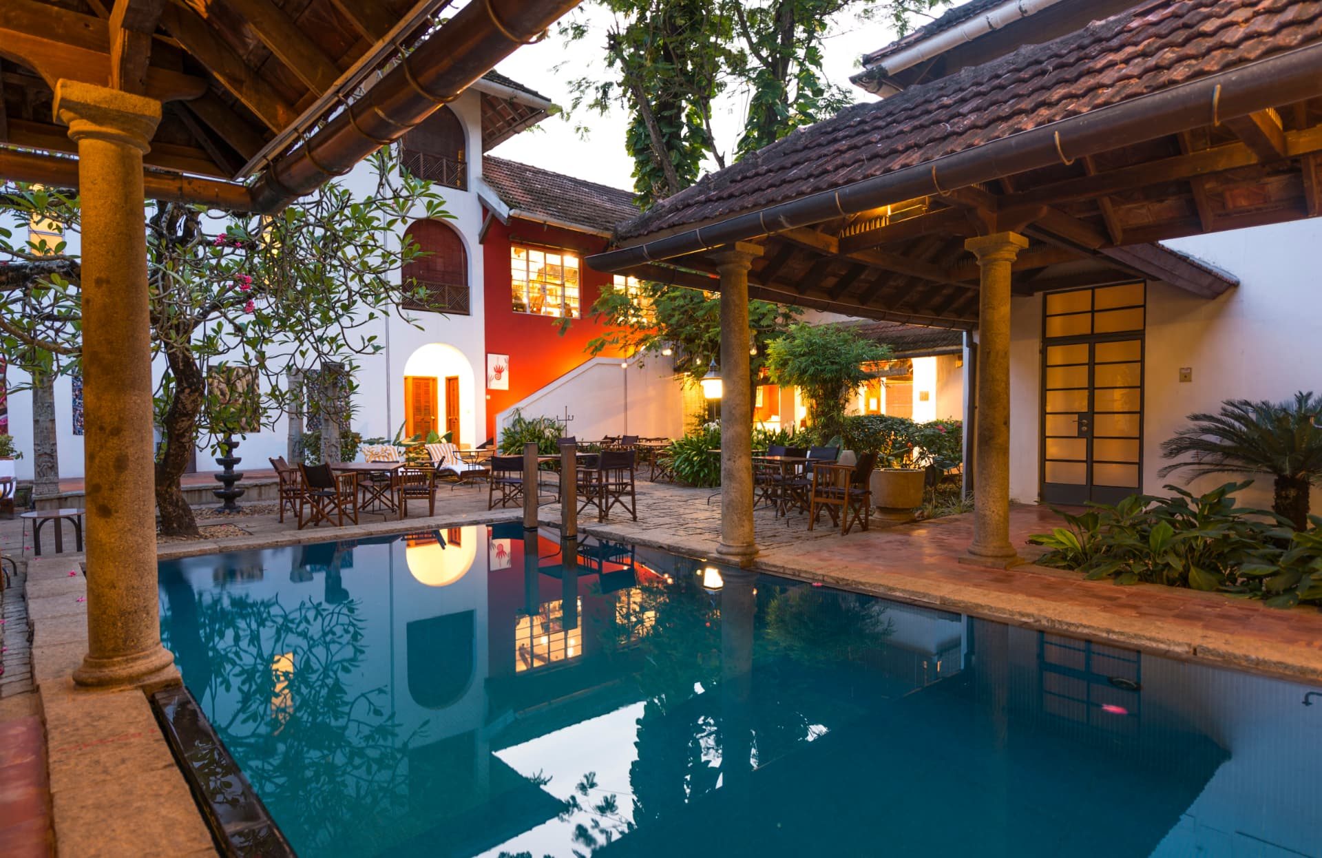 Pool courtyard at dusk at The Malabar House in Fort Kochi