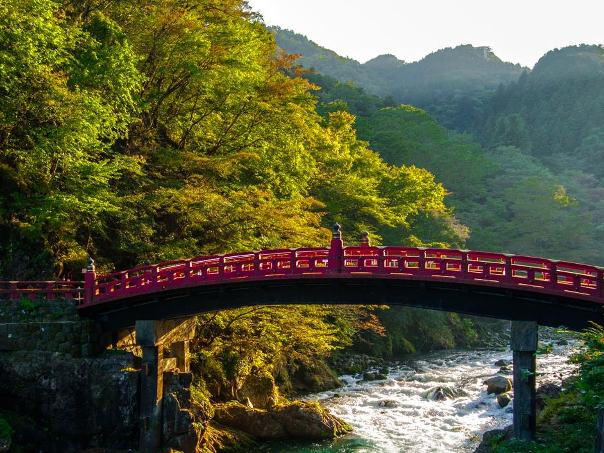 The red Shinkyo bridge over a mountain river at Nikko
