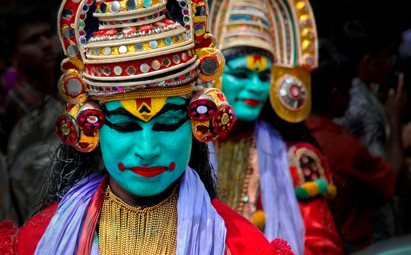 Kathakali performers in full costume and green face paint, Kerala